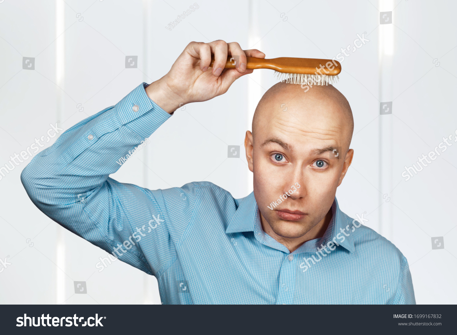 portrait-bald-guy-blue-shirt-holding-stock-photo-1699167832-shutterstock