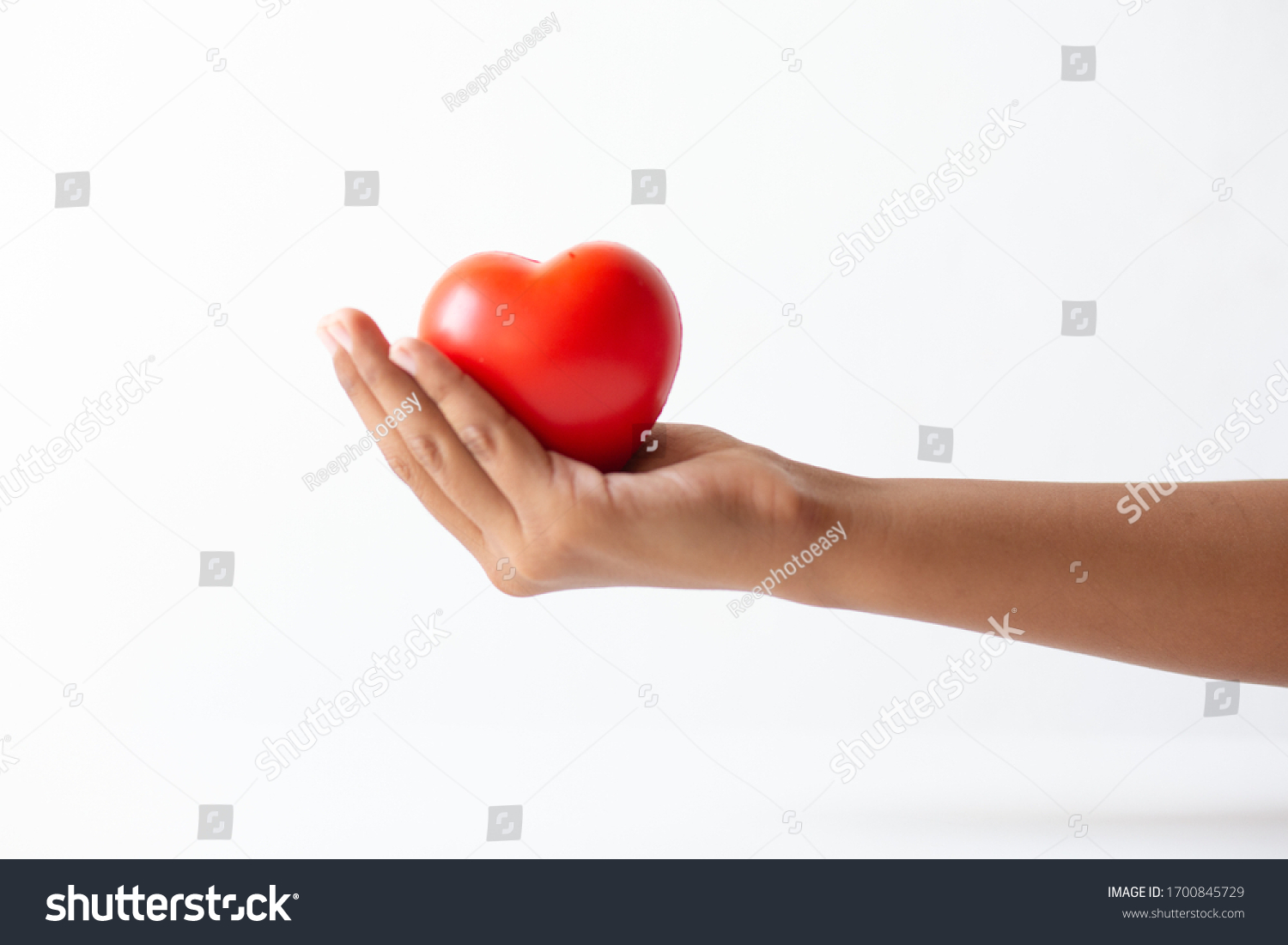 Praying Hands Holding Red Heart Symbol Stock Photo 1700845729