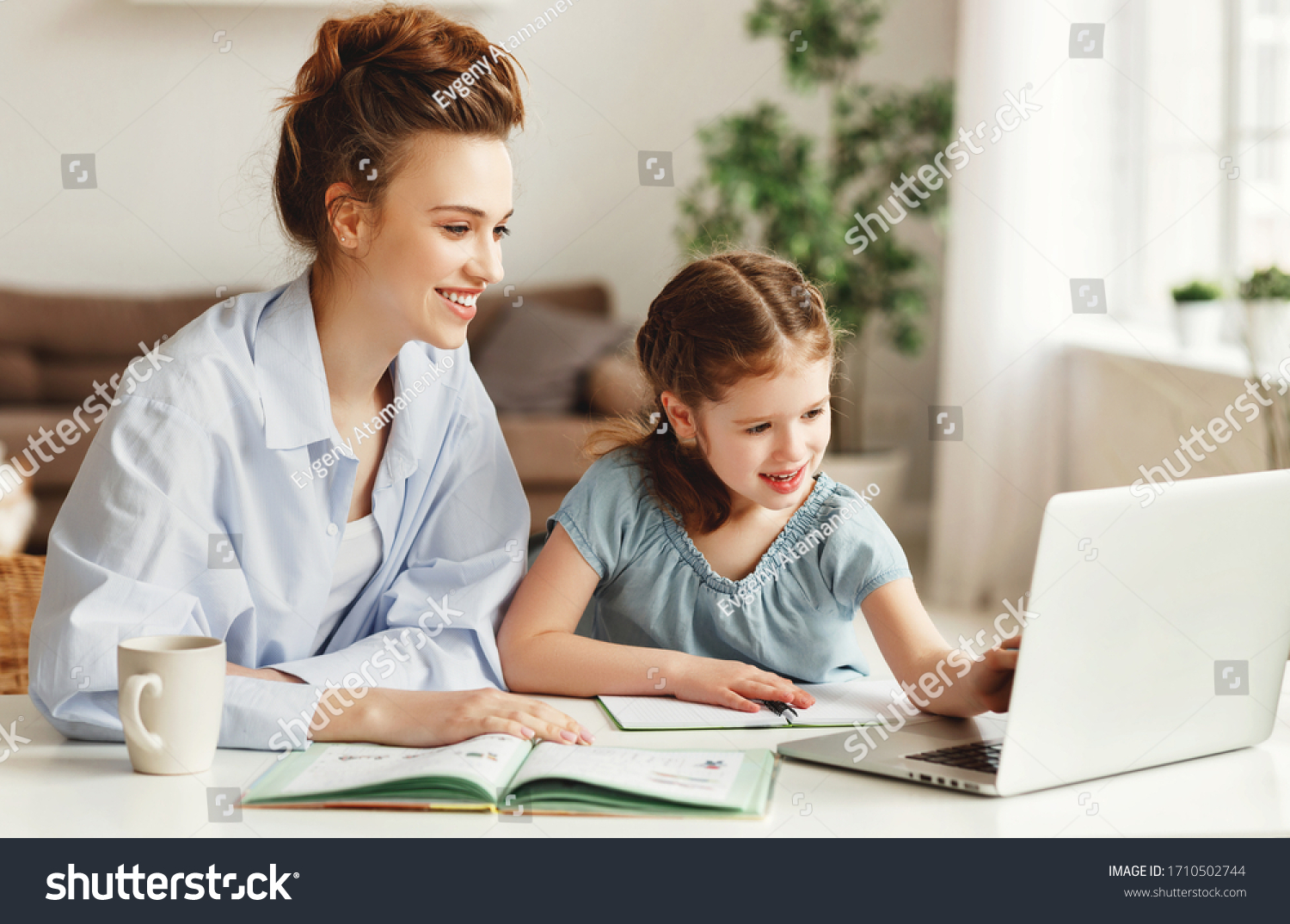 Positive Young Woman Helping Daughter Searching Stock Photo 1710502744 ...