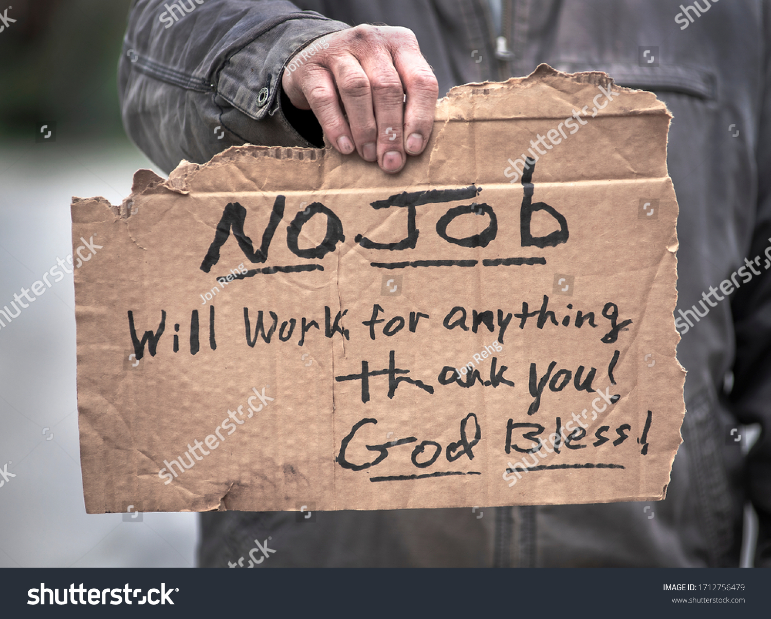 Man Holding Handwritten Cardboard Sign No Stock Photo 1712756479