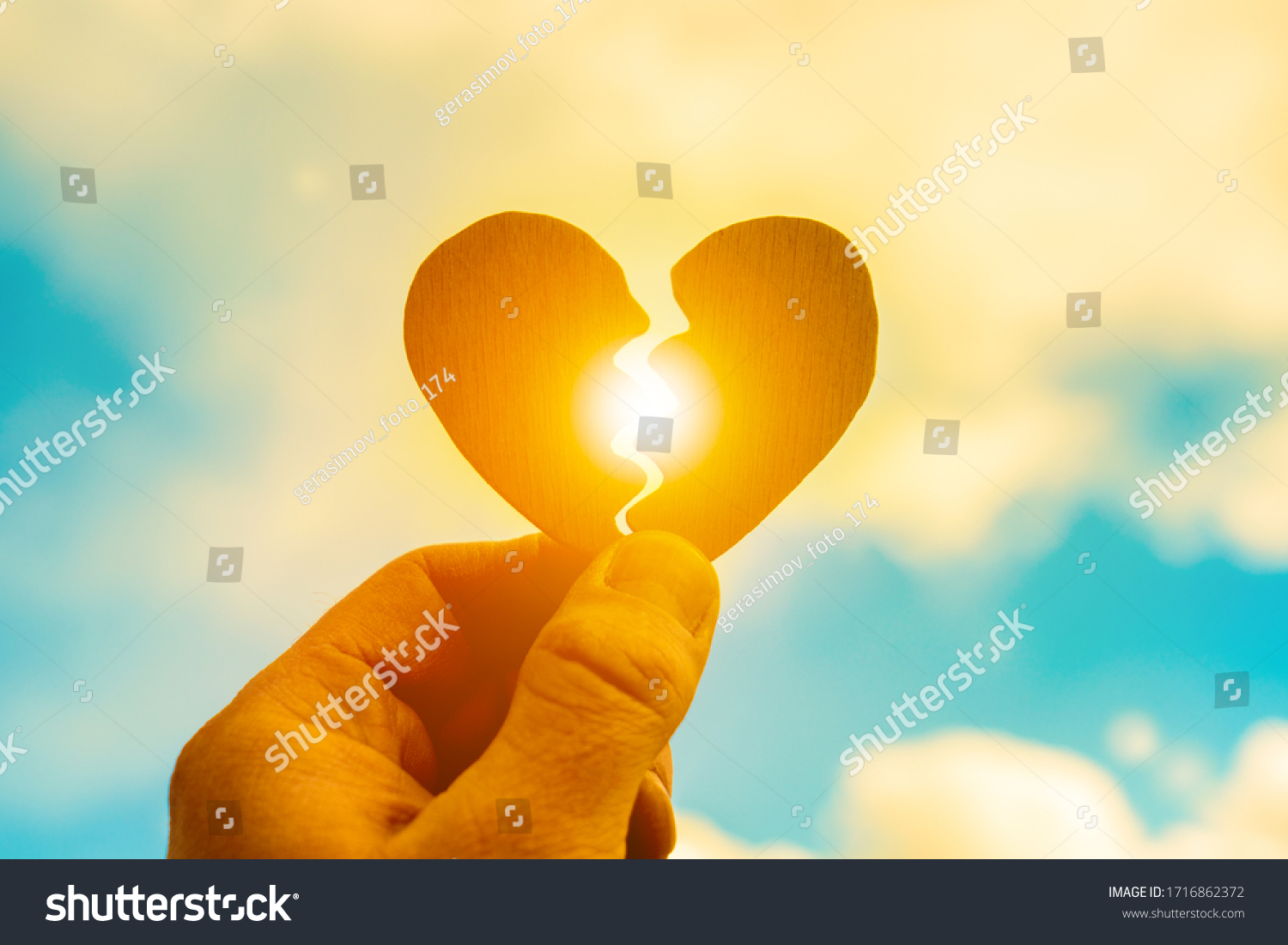 broken-heart-hand-on-sunset-background-stock-photo-1716862372