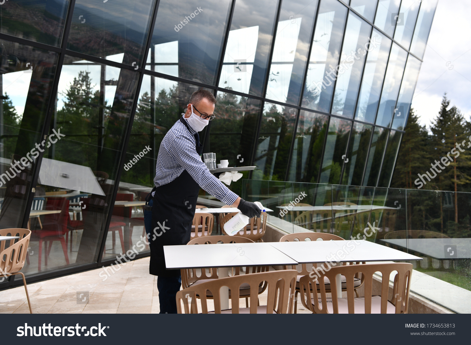 Waiter Cleaning Table Disinfectant Spray Restaurant Stock Photo   Stock Photo Waiter Cleaning The Table With Disinfectant Spray In A Restaurant Wearing Protective Medical Mask 1734653813 