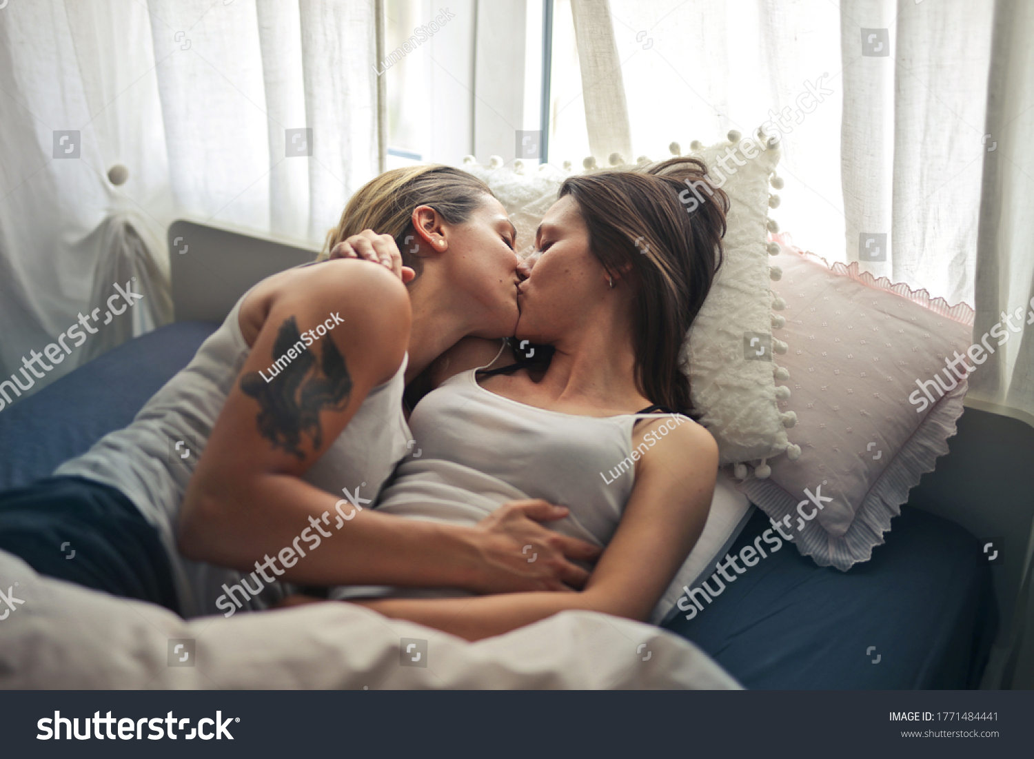 Lesbians Kissing On Bed