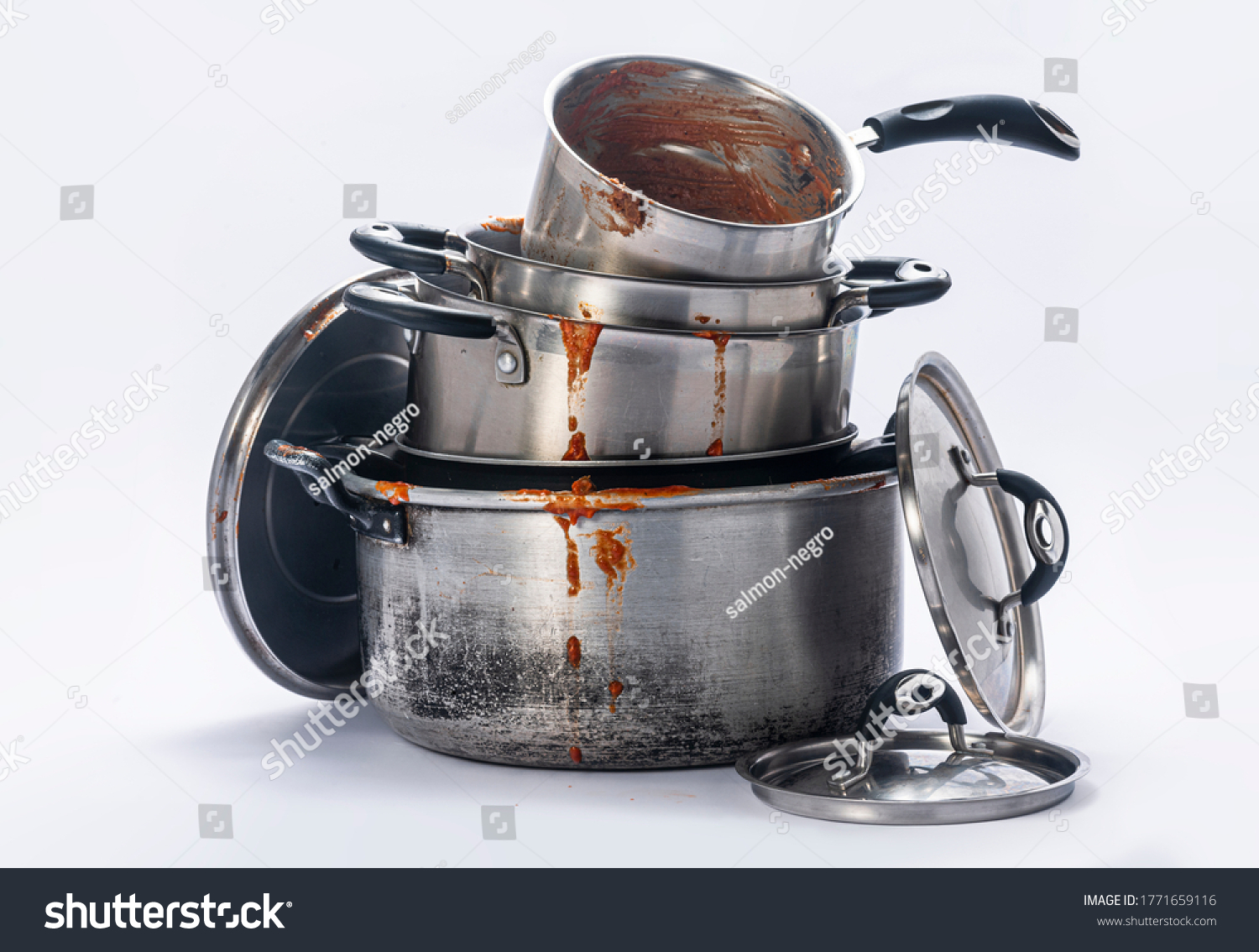 Stock Photo  Dirty Pots And Lids Stacked Together On A White Background 1771659116 