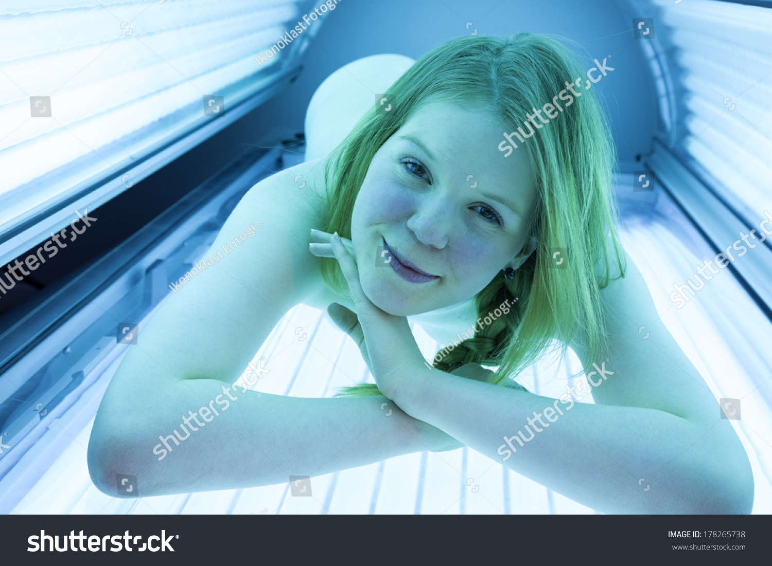 Naked Woman Relaxing On Tanning Bed