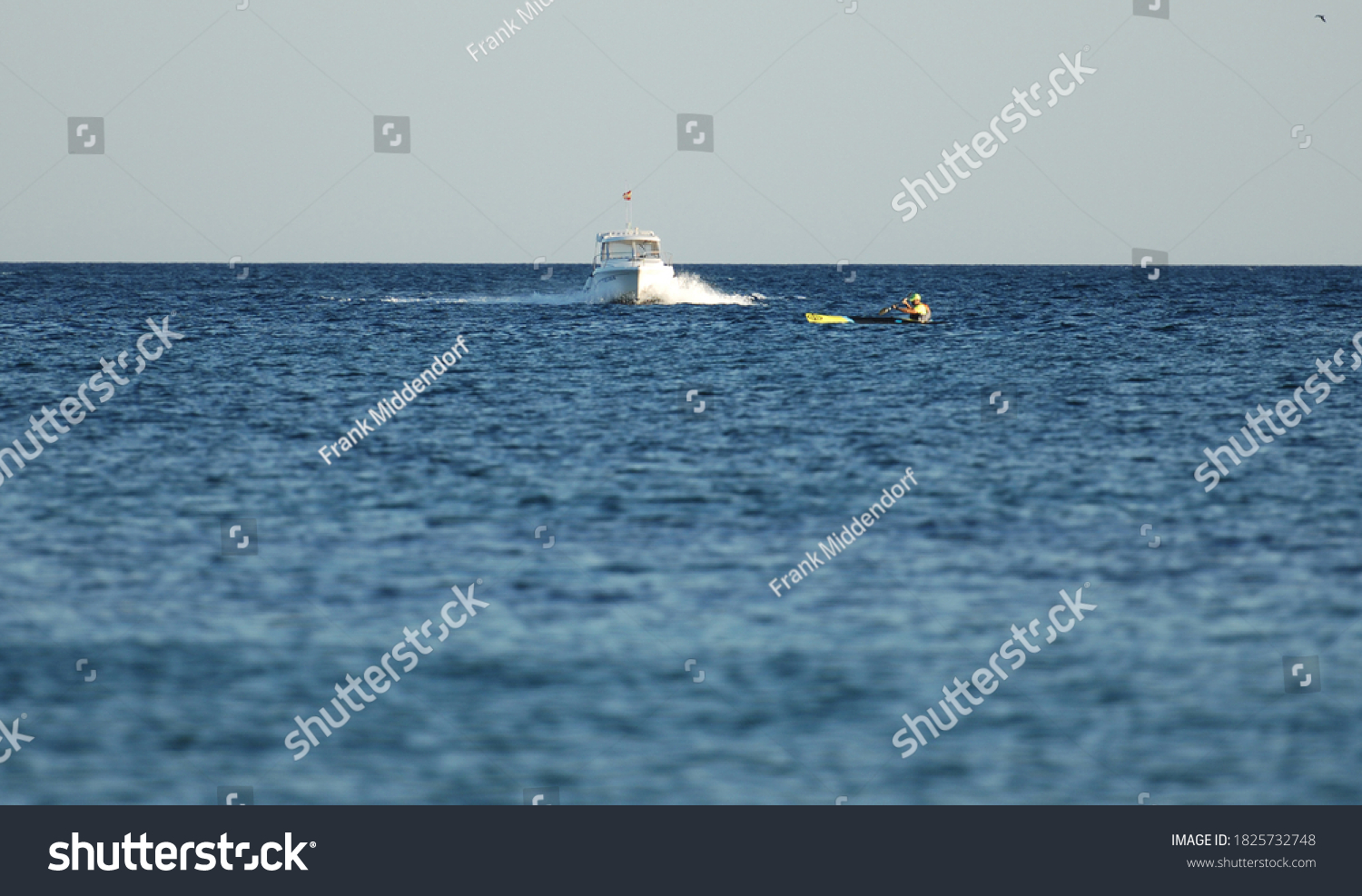 sailboat on a collision course with a fishing boat