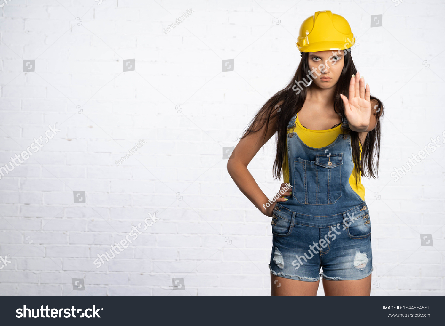 Female Construction Worker Stops Traffic On Stock Photo 1844564581