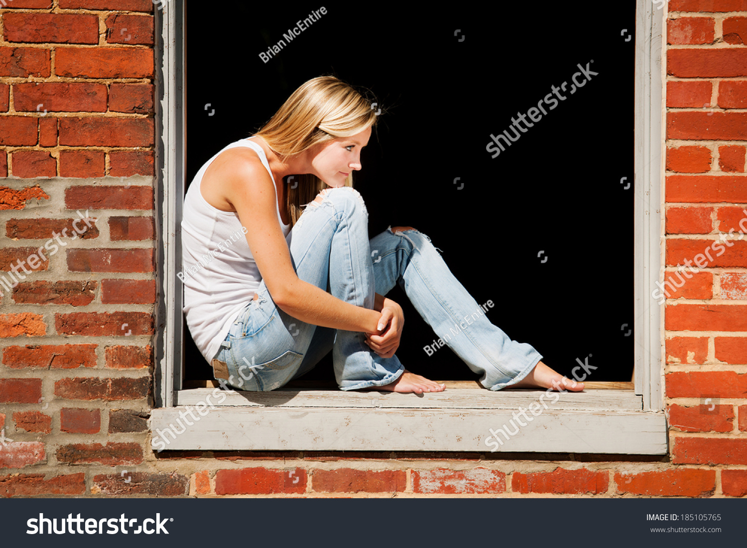 https://image.shutterstock.com/shutterstock/photos/185105765/display_1500/stock-photo-beautiful-young-woman-sits-on-window-ledge-of-abandoned-brick-building-185105765.jpg