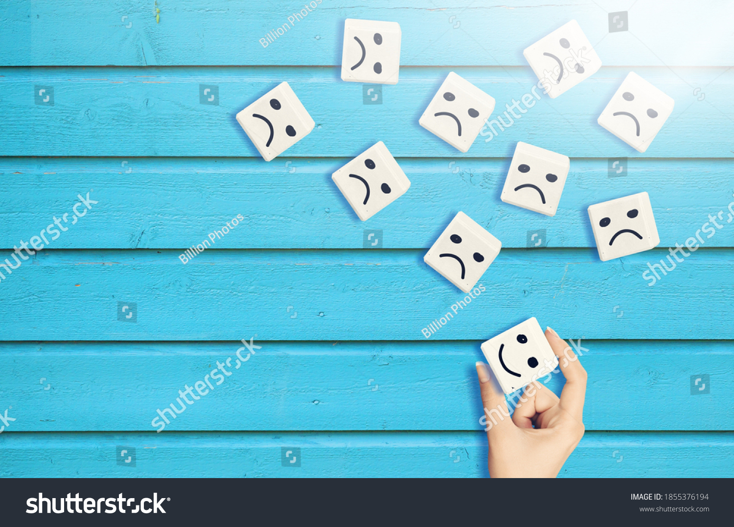 male-hand-chooses-happy-face-among-stock-photo-1855376194-shutterstock