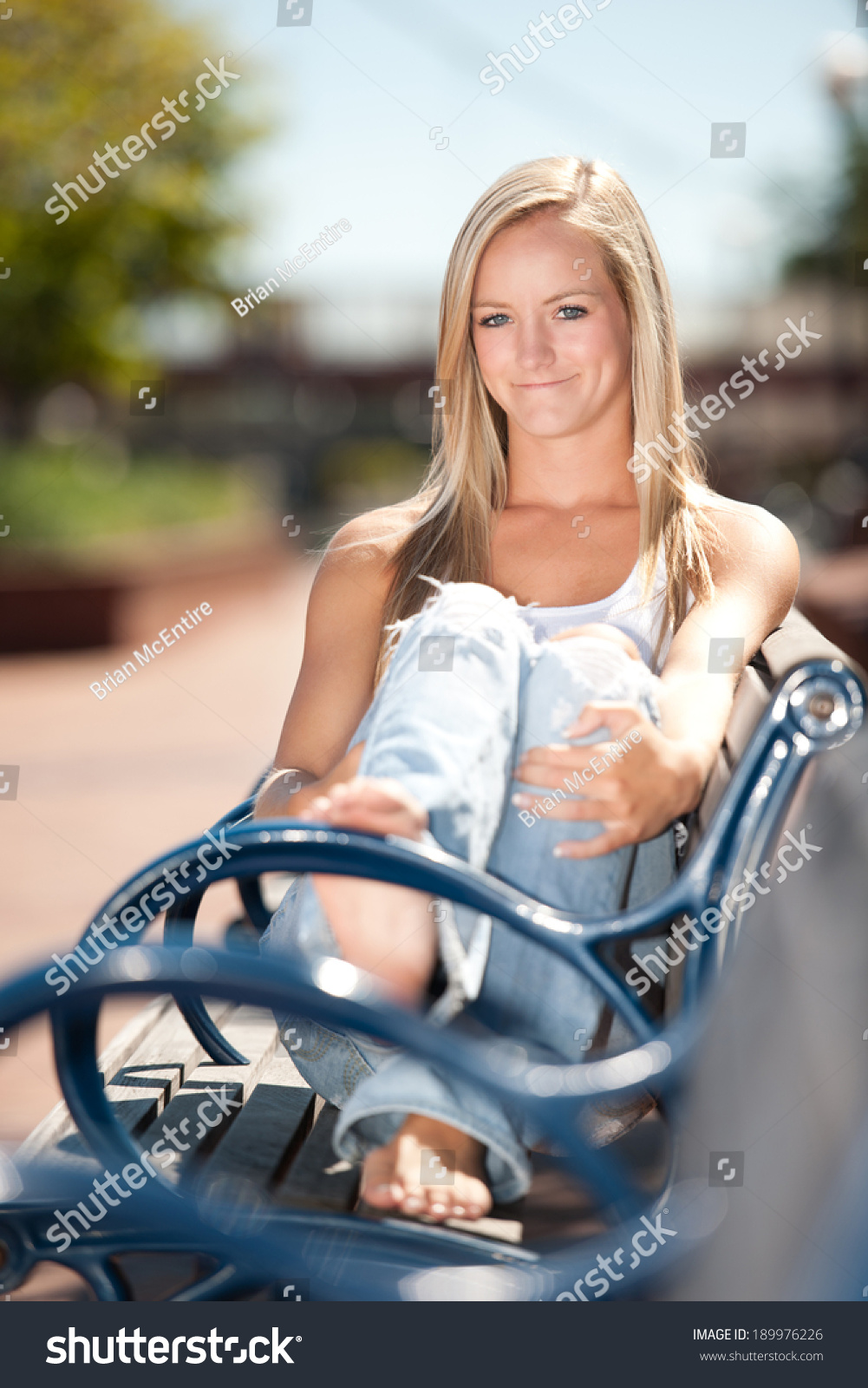 https://image.shutterstock.com/shutterstock/photos/189976226/display_1500/stock-photo-portrait-of-smiling-young-woman-sitting-on-park-bench-189976226.jpg