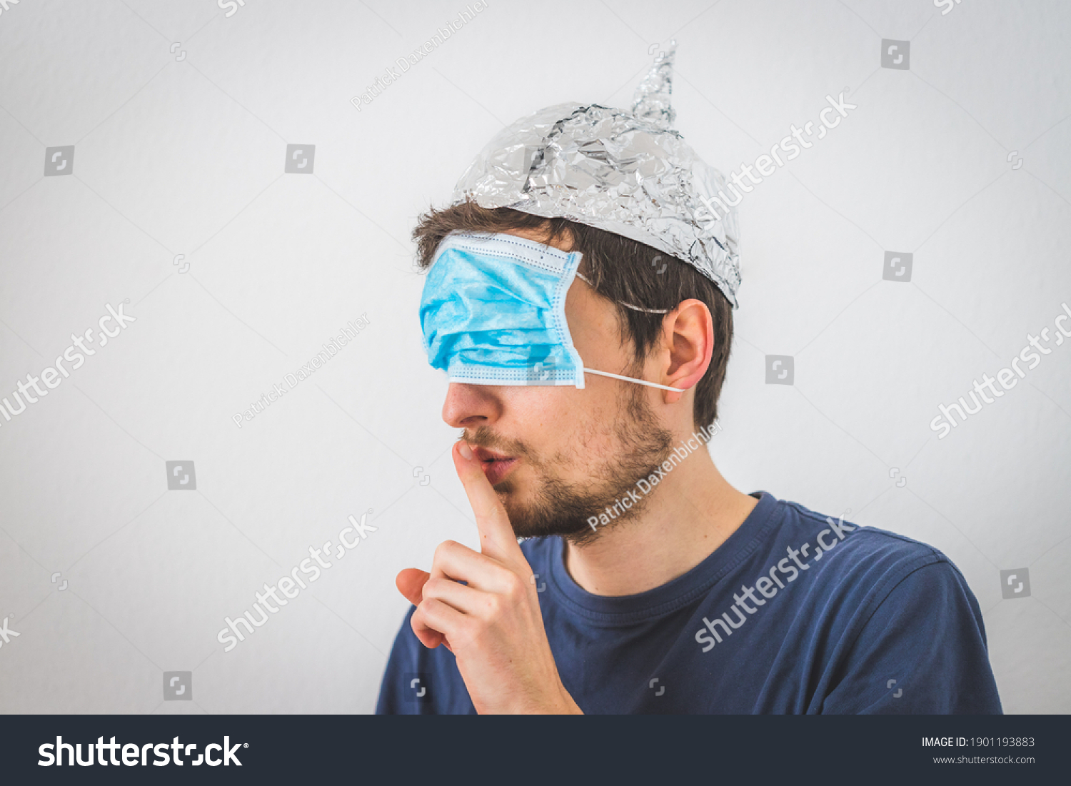 Stock Photo Young Angry Man With Face Mask Over The Eyes And Aluminum Hat Is Doing A Psst Gesture 1901193883 