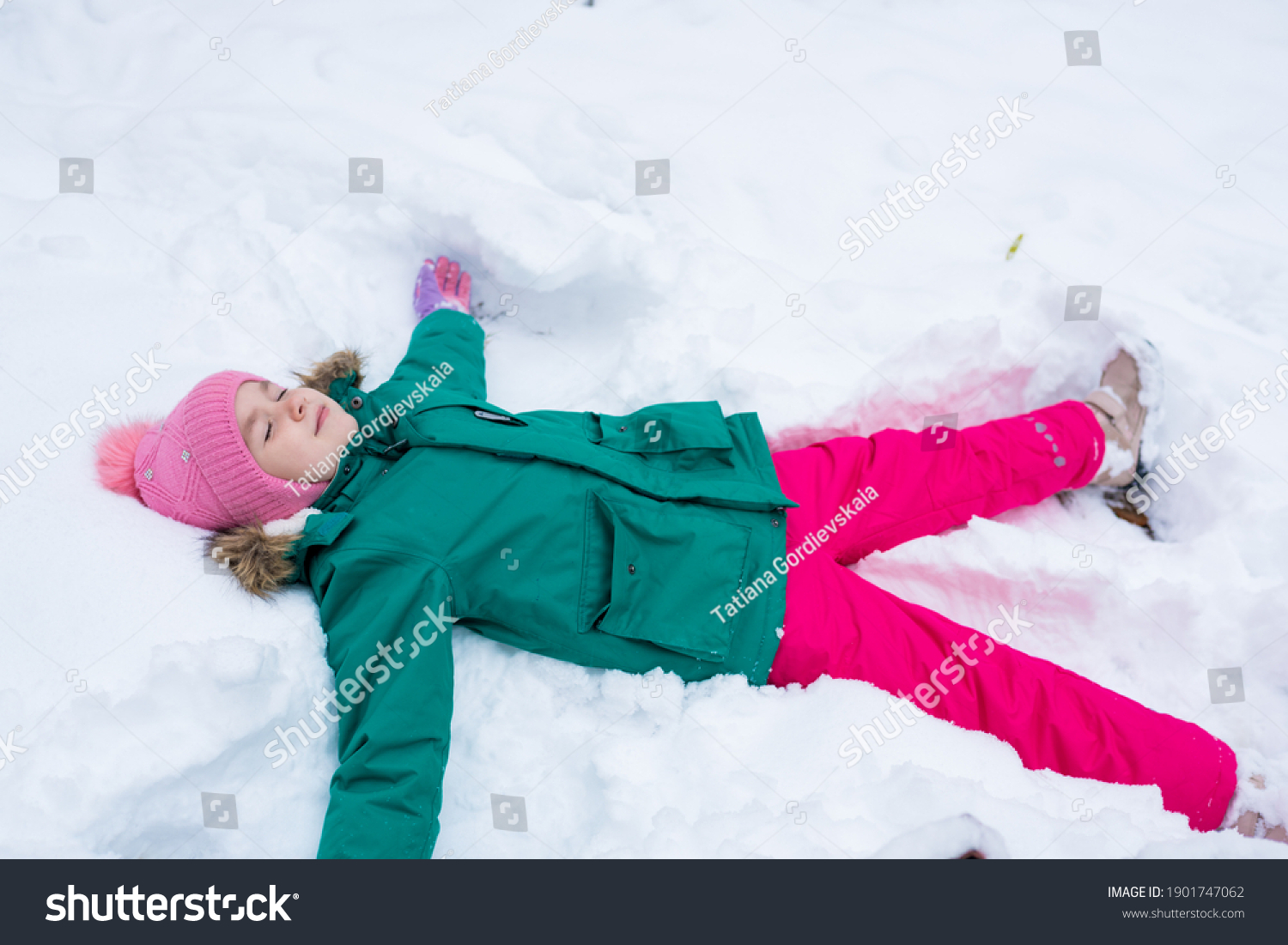 Happy Child Girl Lying On Snow Stock Photo 1901747062 | Shutterstock