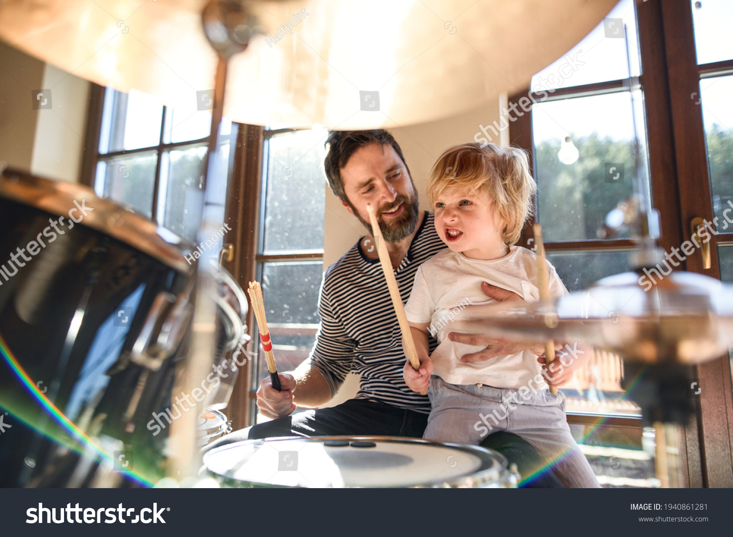 Stock Photo Small Boy With Father Indoors At Home Playing Drums 1940861281 