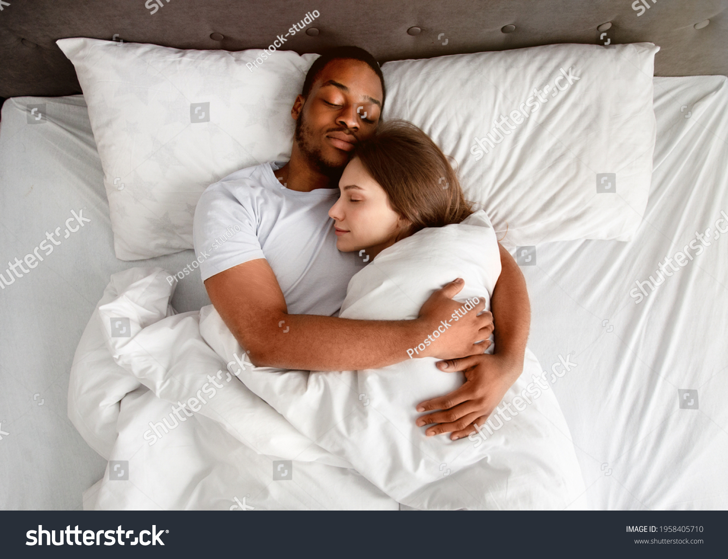 Top View Of Affectionate Multiracial Couple Hugging Each Other While