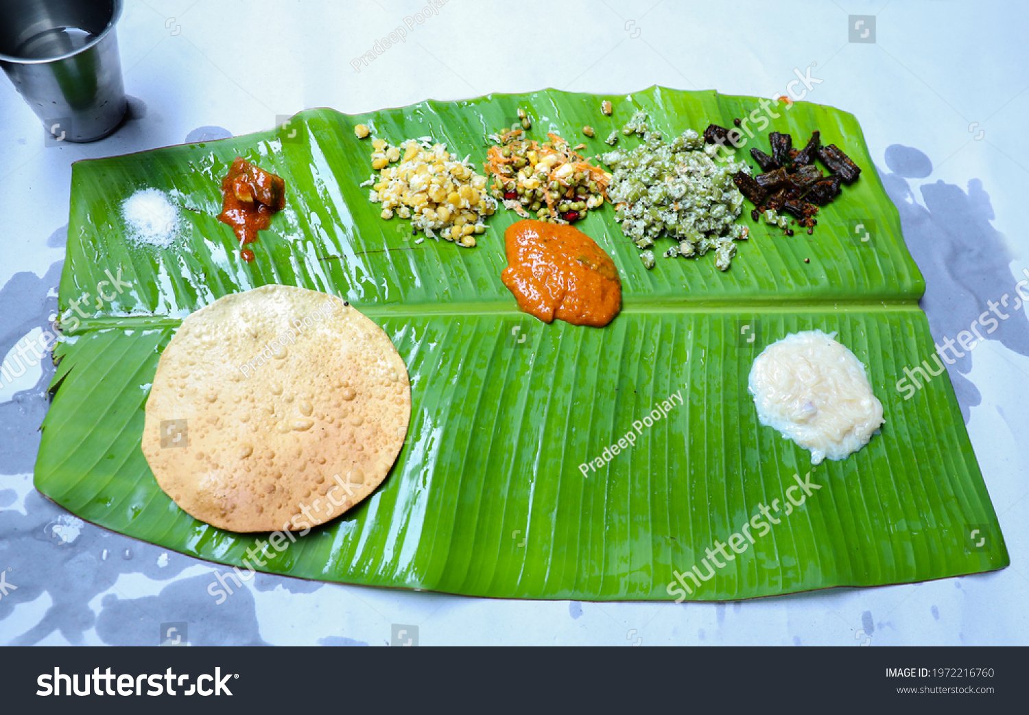 Traditional South Indian Veg Mealstarters On Stock Photo 1972216760   Stock Photo Traditional South Indian Veg Meal Starters On A Banana Leaf 1972216760 