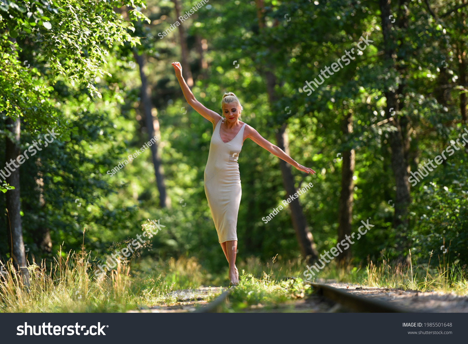 https://image.shutterstock.com/shutterstock/photos/1985501648/display_1500/stock-photo-caucasian-blonde-barefoot-model-in-nude-dress-walks-along-the-along-railroad-on-a-summer-day-1985501648.jpg