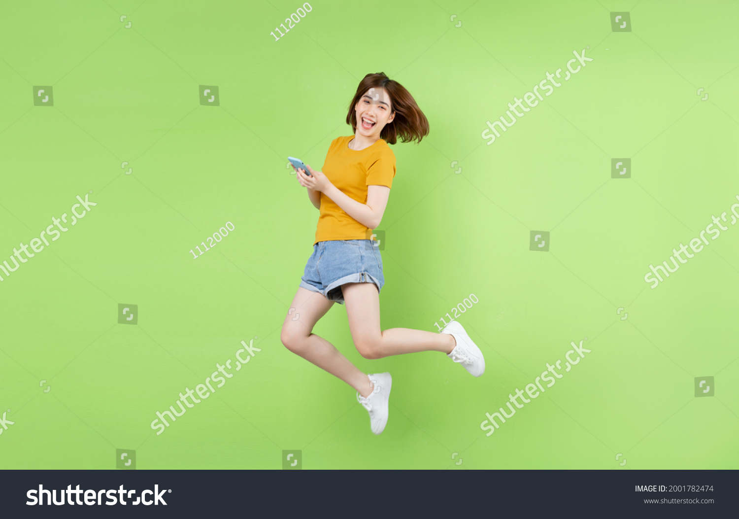 Young Asian Girl Jumping On Green Stock Photo 2001782474 | Shutterstock