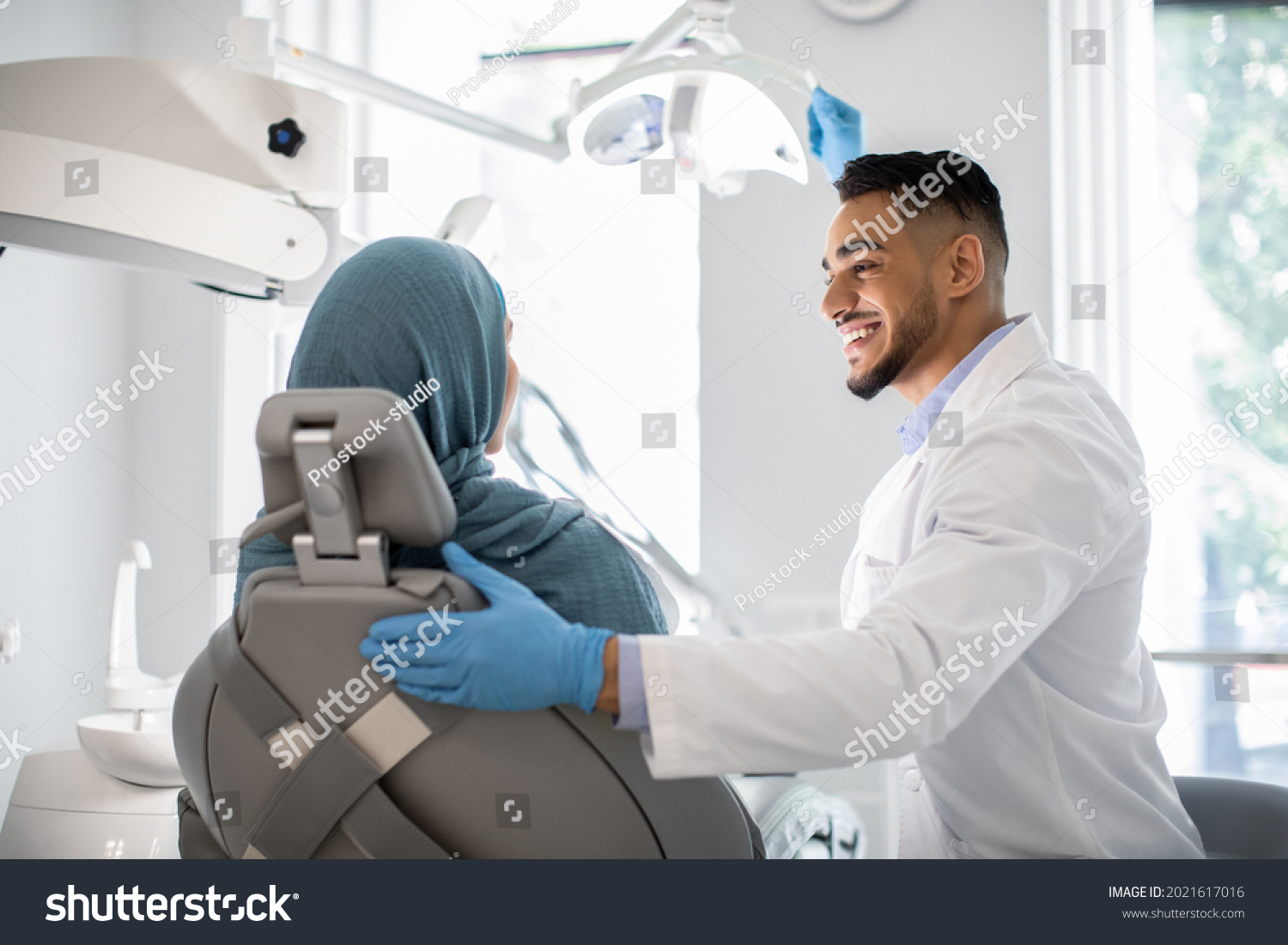 Stock Photo Dental Treatment Arab Dentist Doctor Making Check Up To Muslim Female Patient In Stomatological 2021617016 