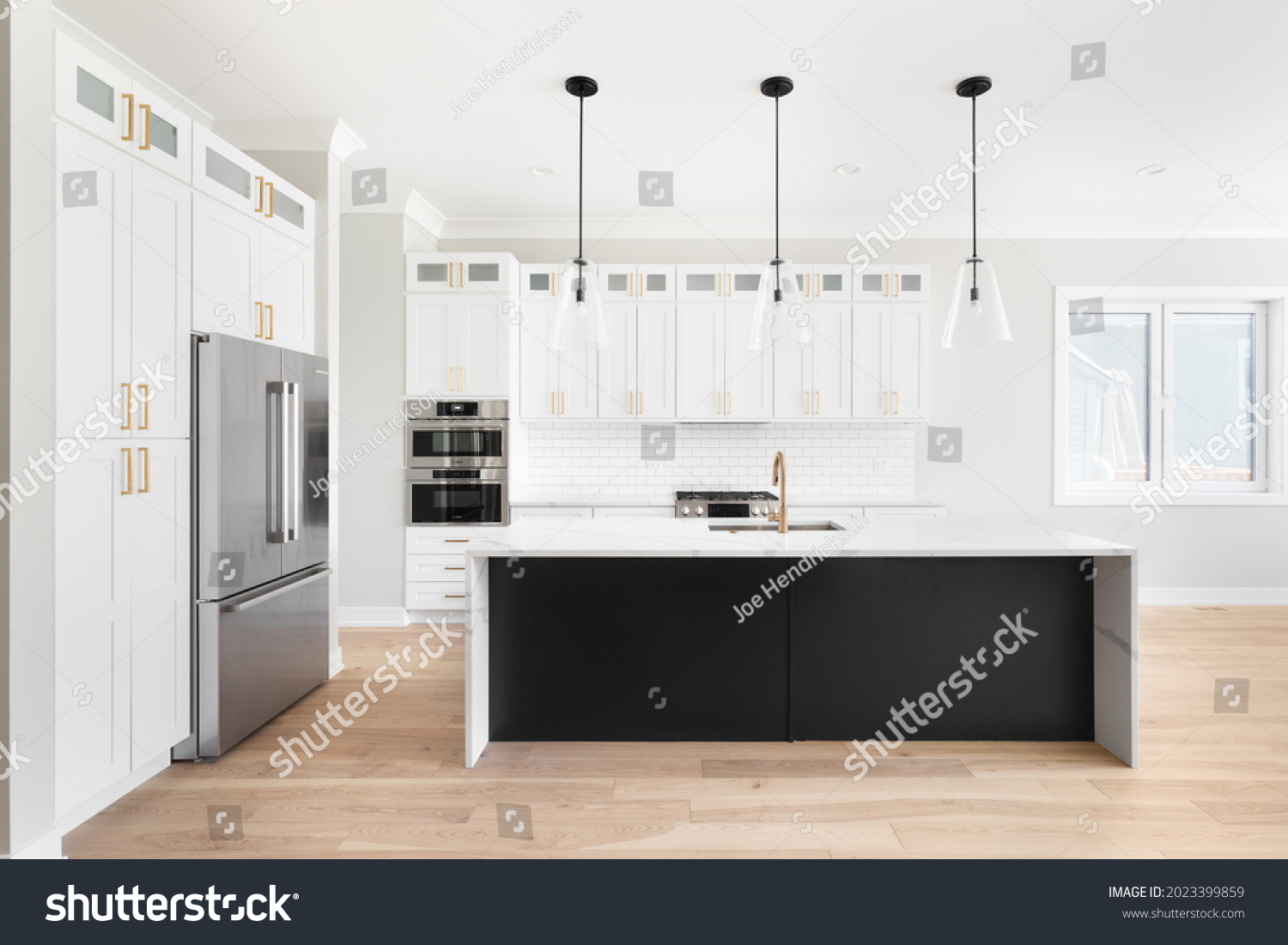 Elmhurst Il Usa June 2 2021 Stock Photo 2023399859 Shutterstock   Stock Photo Elmhurst Il Usa June A Luxury White Kitchen With Black Pendant Lights Hanging Above A 2023399859 