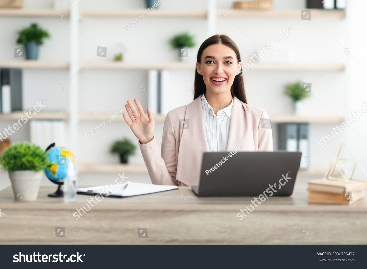 Cheerful Female Manager Waving Hello Sitting Stock Photo 2030795477 ...