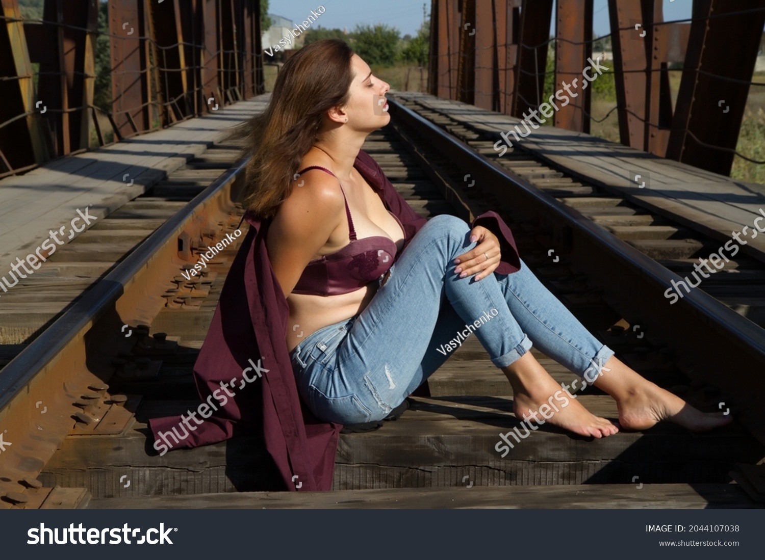 https://image.shutterstock.com/shutterstock/photos/2044107038/display_1500/stock-photo-the-girl-sits-on-the-railway-sleepers-and-looks-into-the-distance-2044107038.jpg