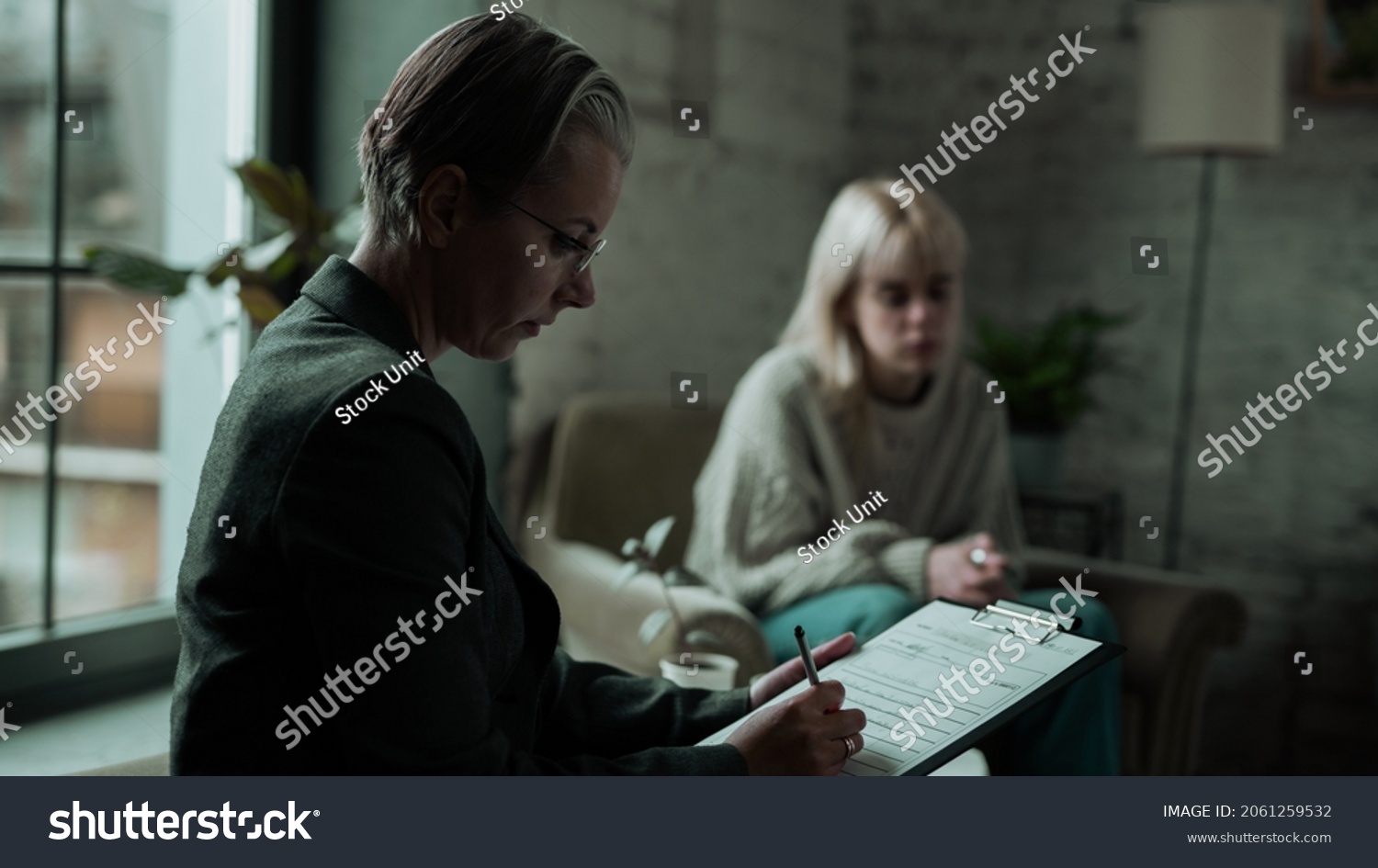 middle-aged-psychiatrist-short-hair-writing-stock-photo-2061259532