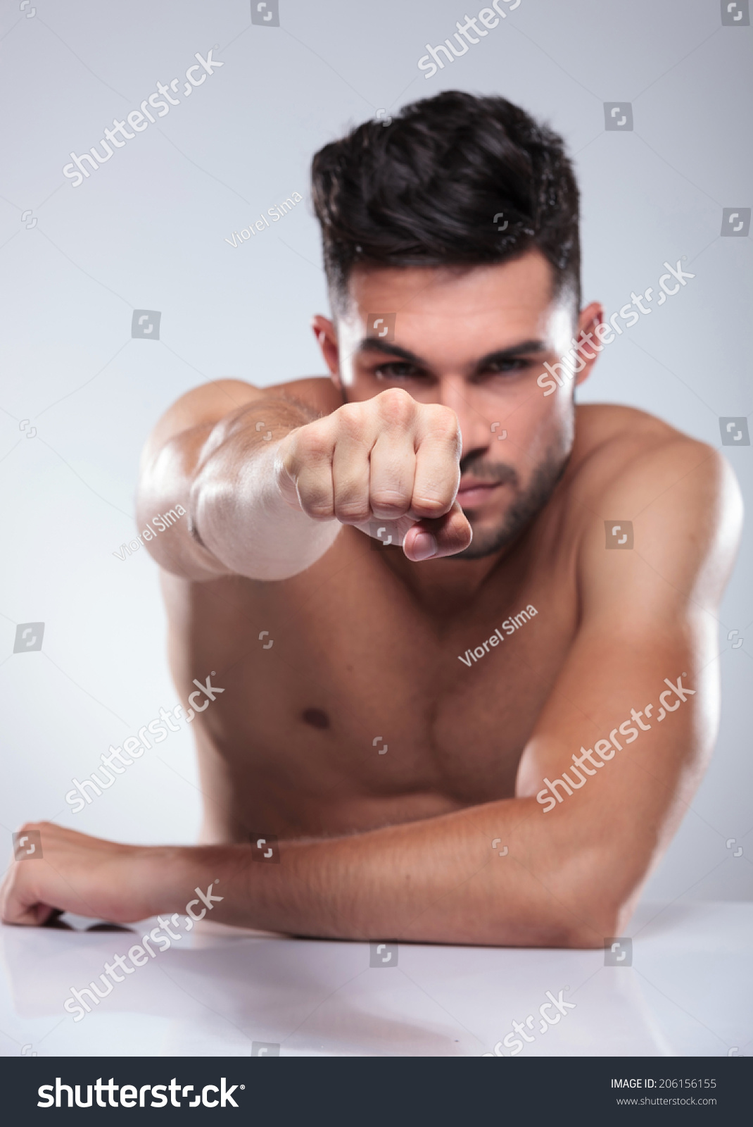 Naked Man Throwing Punch While Seated Stock Photo Shutterstock