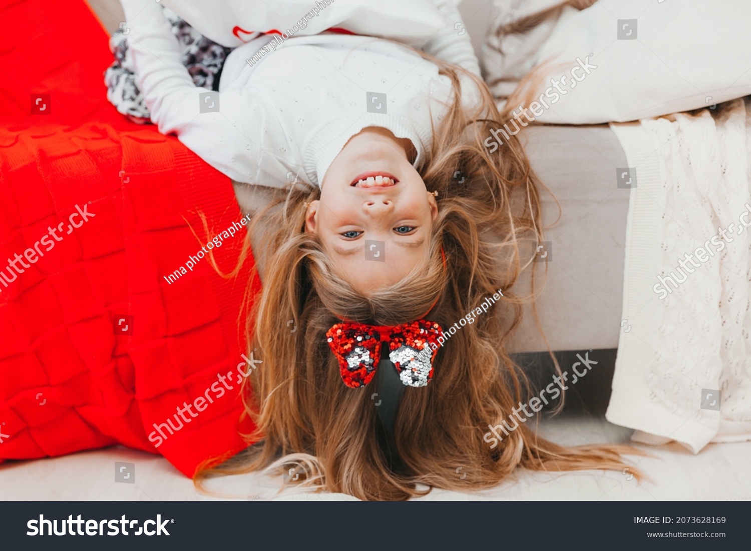 portrait-playful-girl-lying-upside-down-stock-photo-2073628169