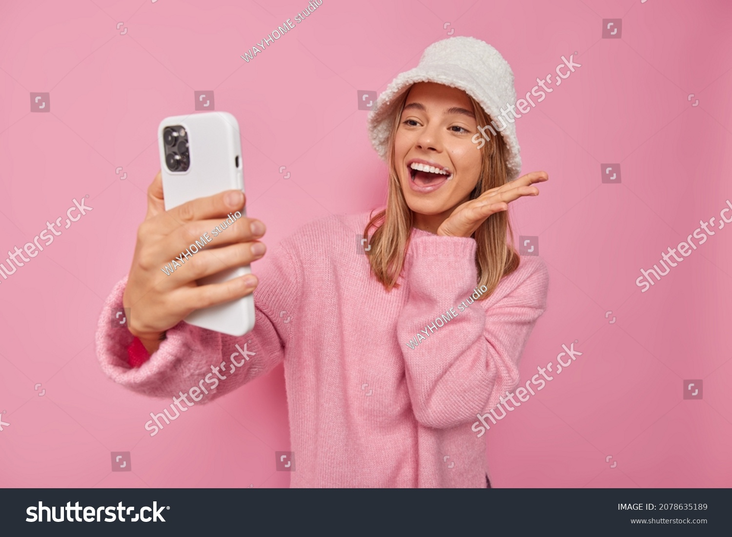 positive-good-looking-woman-exclaimsgladfully-concentrated-stock-photo