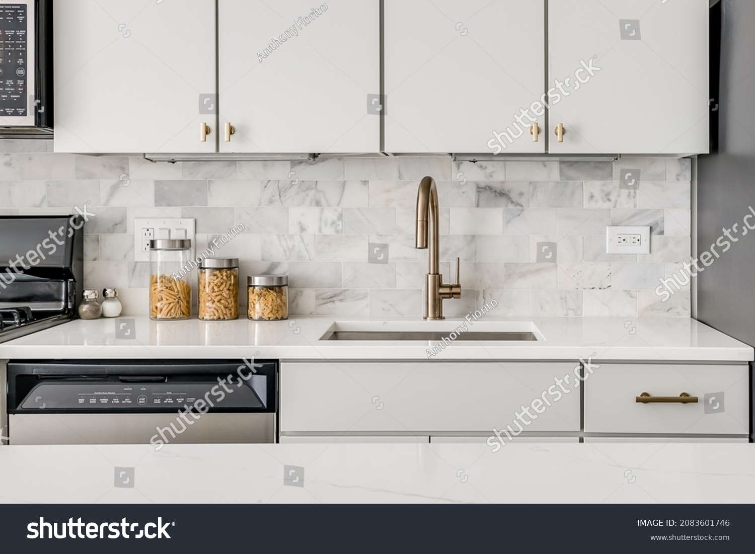 white kitchen sink with gold faucet