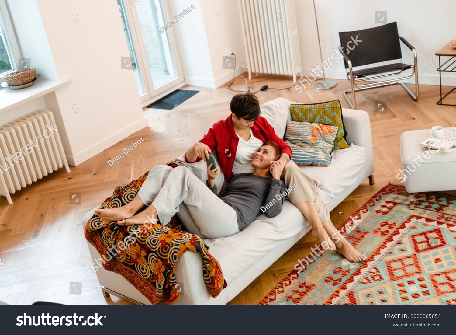 Стоковая фотография 2088865654: Mature Lesbian Couple Using Mobile Phone |  Shutterstock