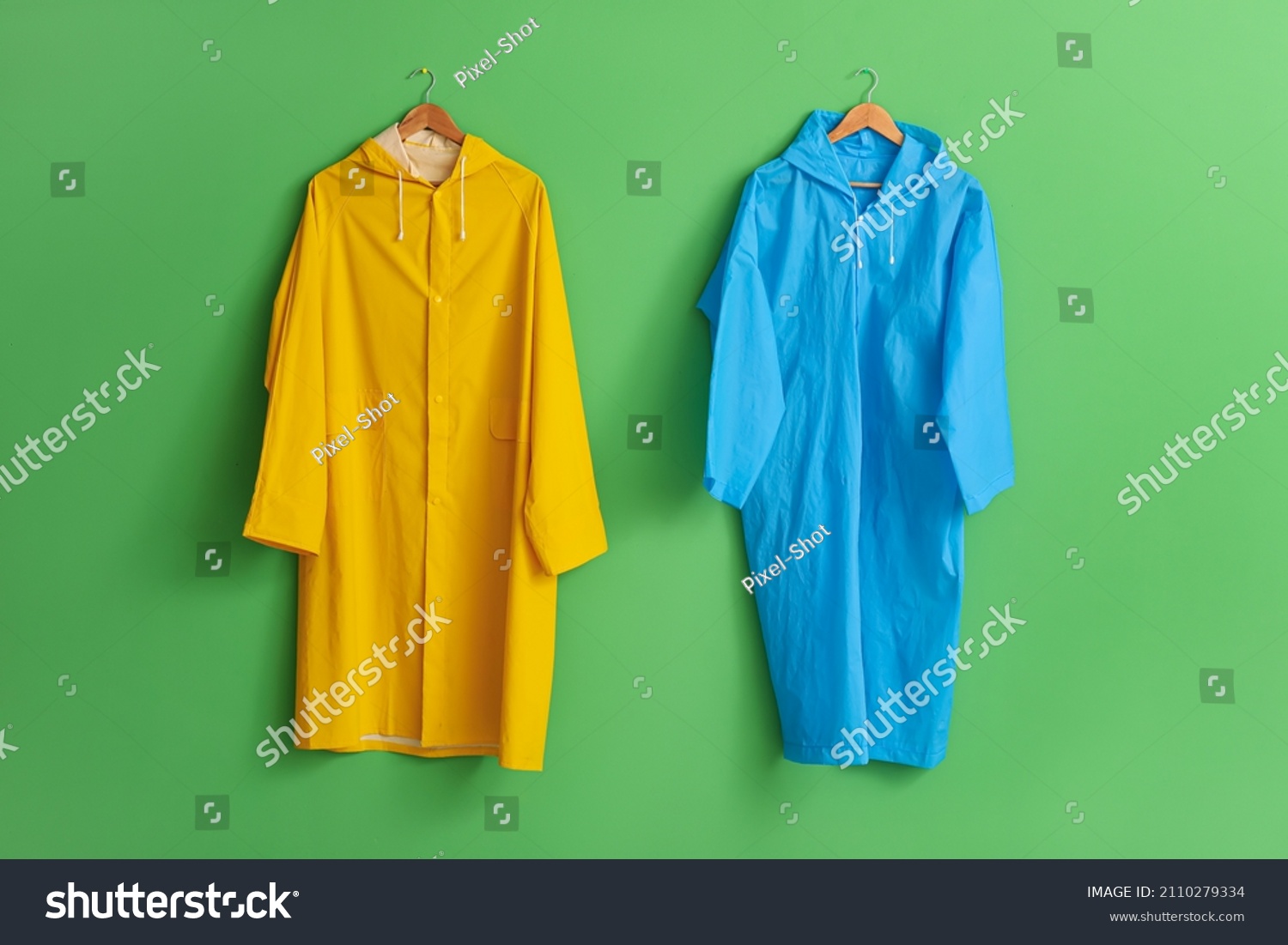 Bright Raincoats Hanging On Green Wall Stock Photo 2110279334 ...