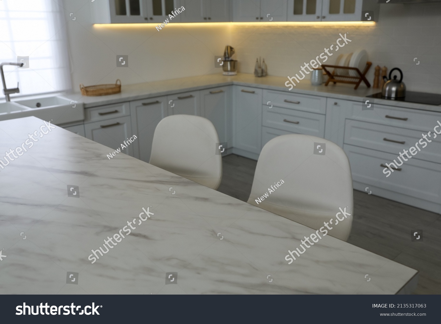 Modern Kitchen Interior White Marble Table Stock Photo 2135317063   Stock Photo Modern Kitchen Interior With White Marble Table And Stylish Chairs 2135317063 