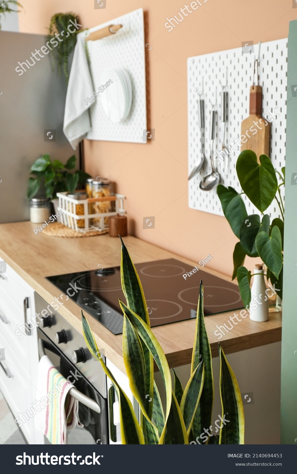 Modern Kitchen Wooden Counter Pegboards Utensils Stock Photo 2140694453   Stock Photo Modern Kitchen With Wooden Counter And Pegboards With Utensils On Color Wall 2140694453 