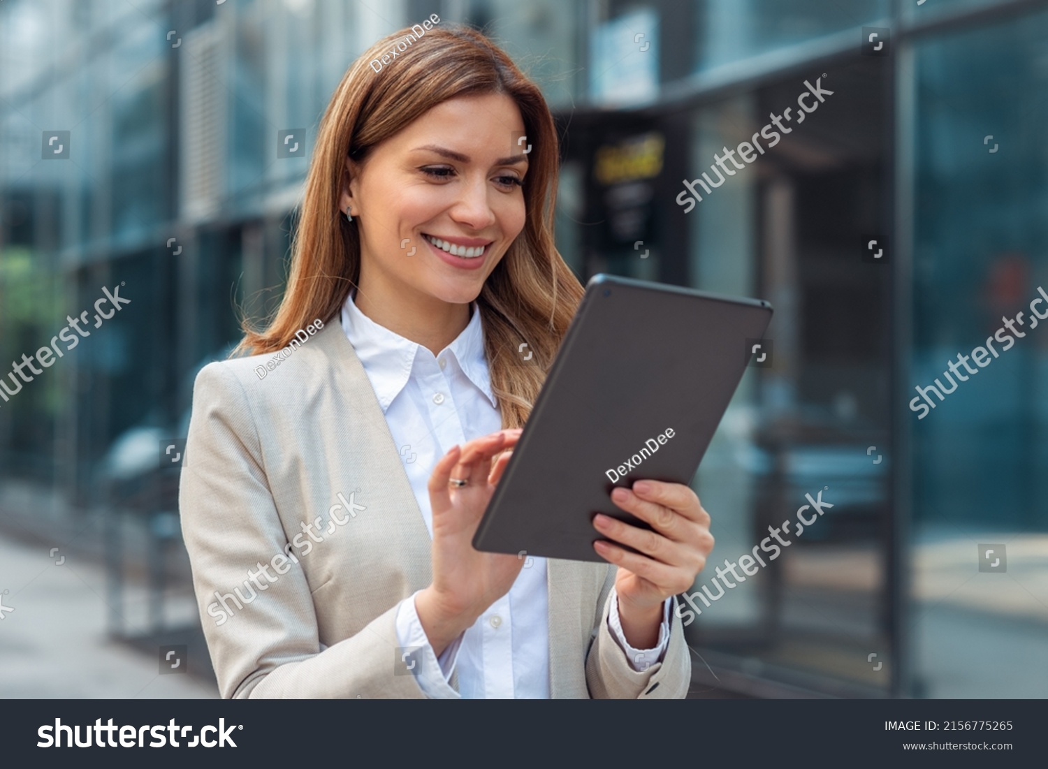 Portrait Of A Successful Business Woman Using Digital Tablet In Office