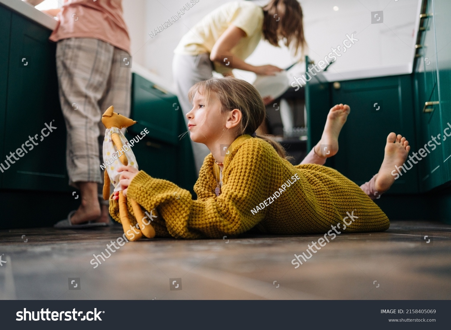 Stock Photo A Lesbian Family Is Doing Household Chores In The Kitchen And Their Daughter In A Yellow Sweater 2158405069 