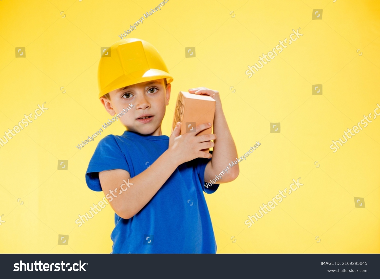 Boy Construction Helmet Holds Brick His Stock Photo 2169295045 ...