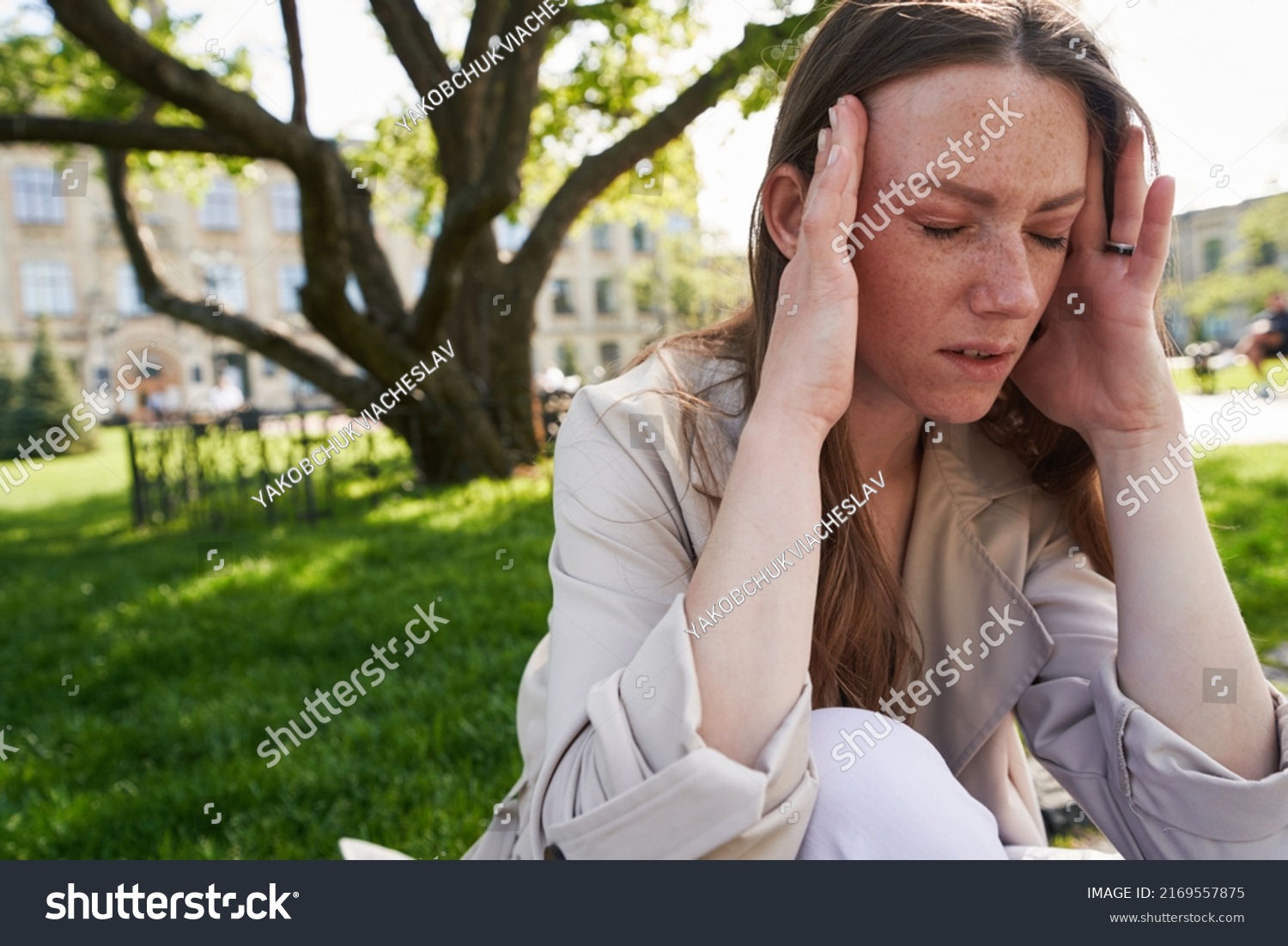 woman-eyes-shut-holding-head-hands-stock-photo-2169557875-shutterstock