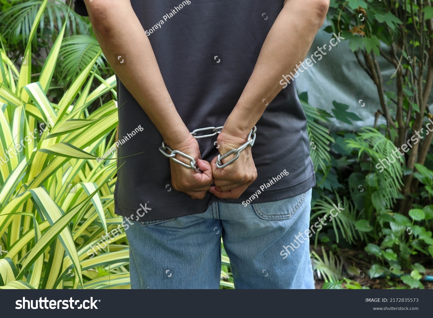 man-hands-tied-behind-steel-chain-stock-photo-2172835573-shutterstock