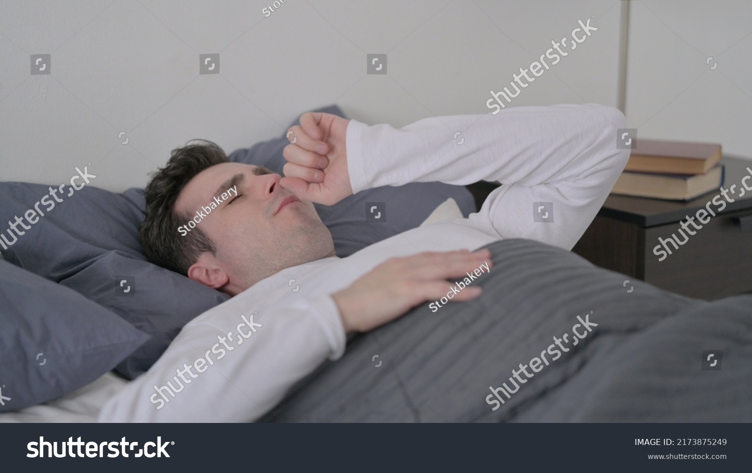 man-coughing-while-sleeping-bed-stock-photo-2173875249-shutterstock