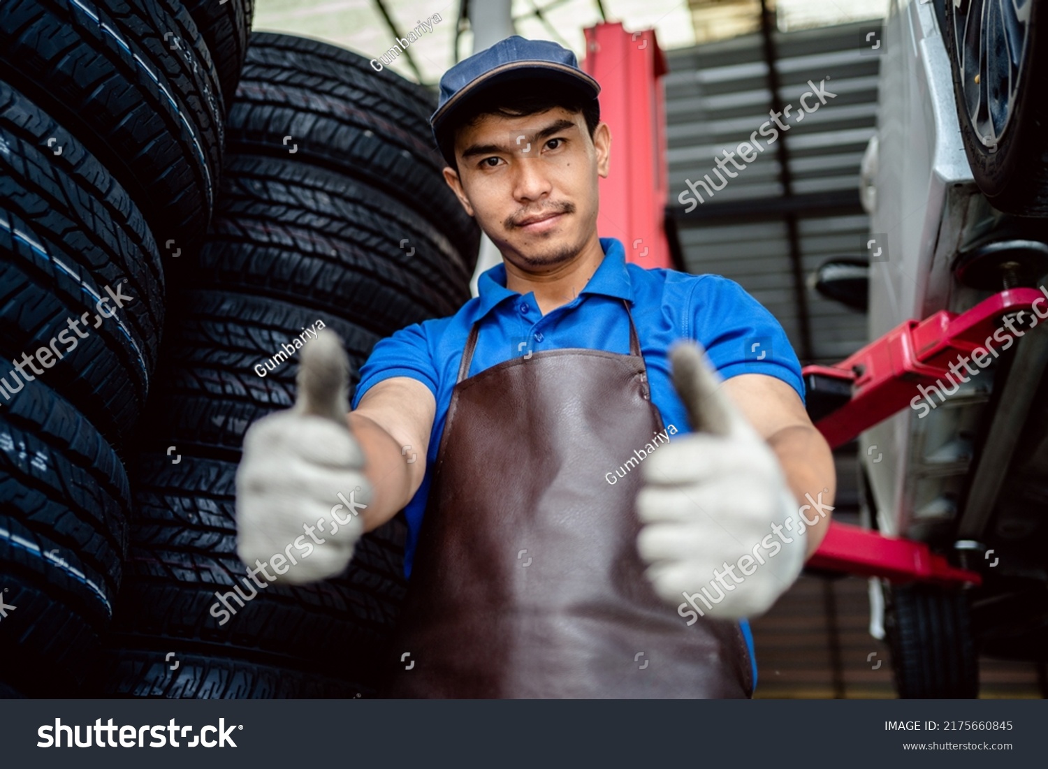 Auto Mechanic Repairman Smiles Thumbs Looking Stock Photo 2175660845