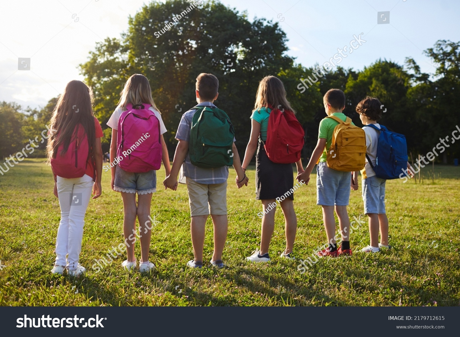 Schoolchildren Backpacks On Their Shoulders Holding Stock Photo ...