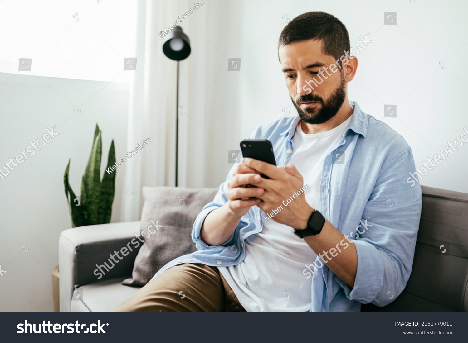 Young Brazilian Man Sitting On Sofa Stock Photo 2181779011 | Shutterstock