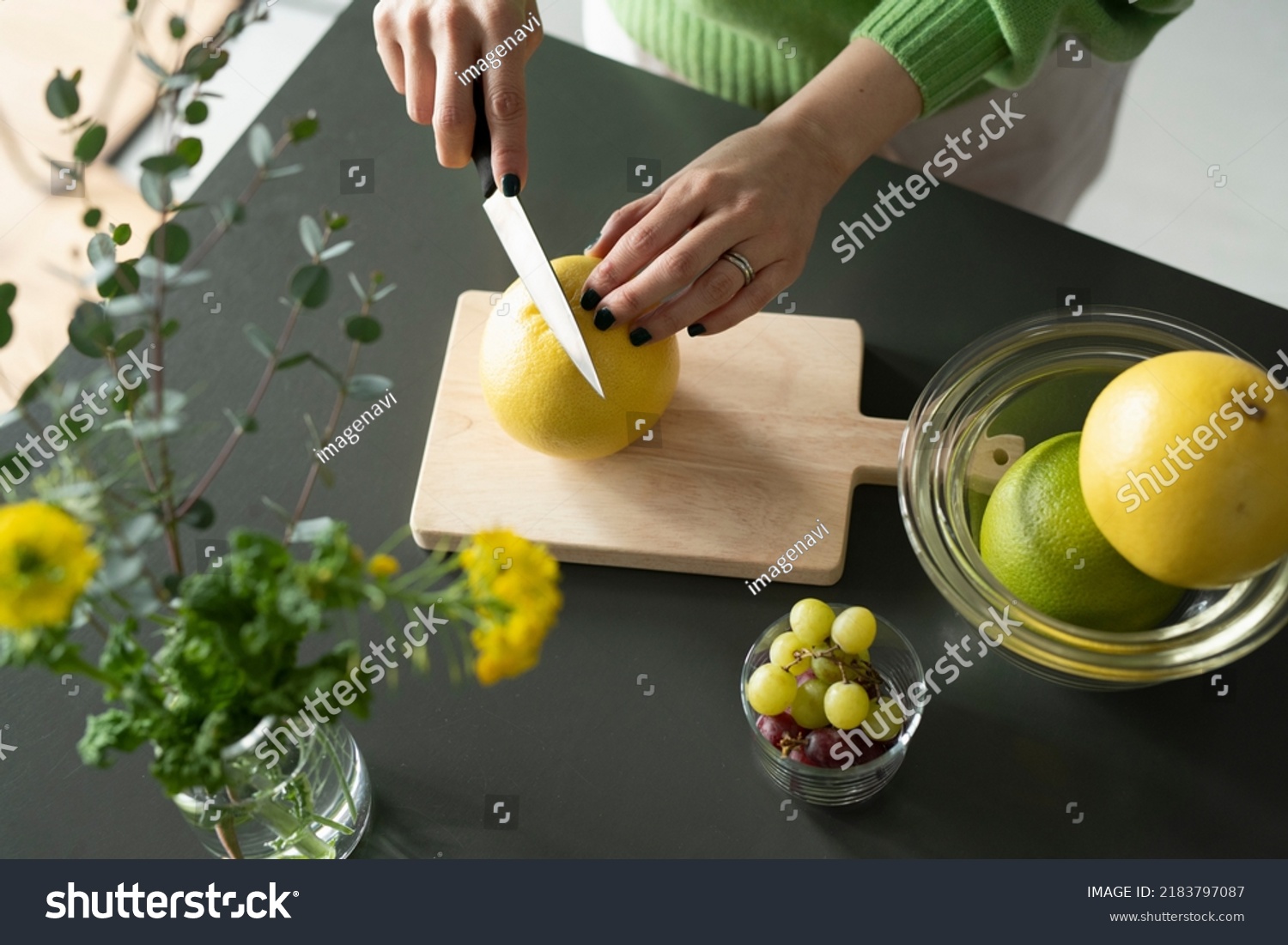 horizontal-shot-japanese-woman-cutting-grapefruit-stock-photo