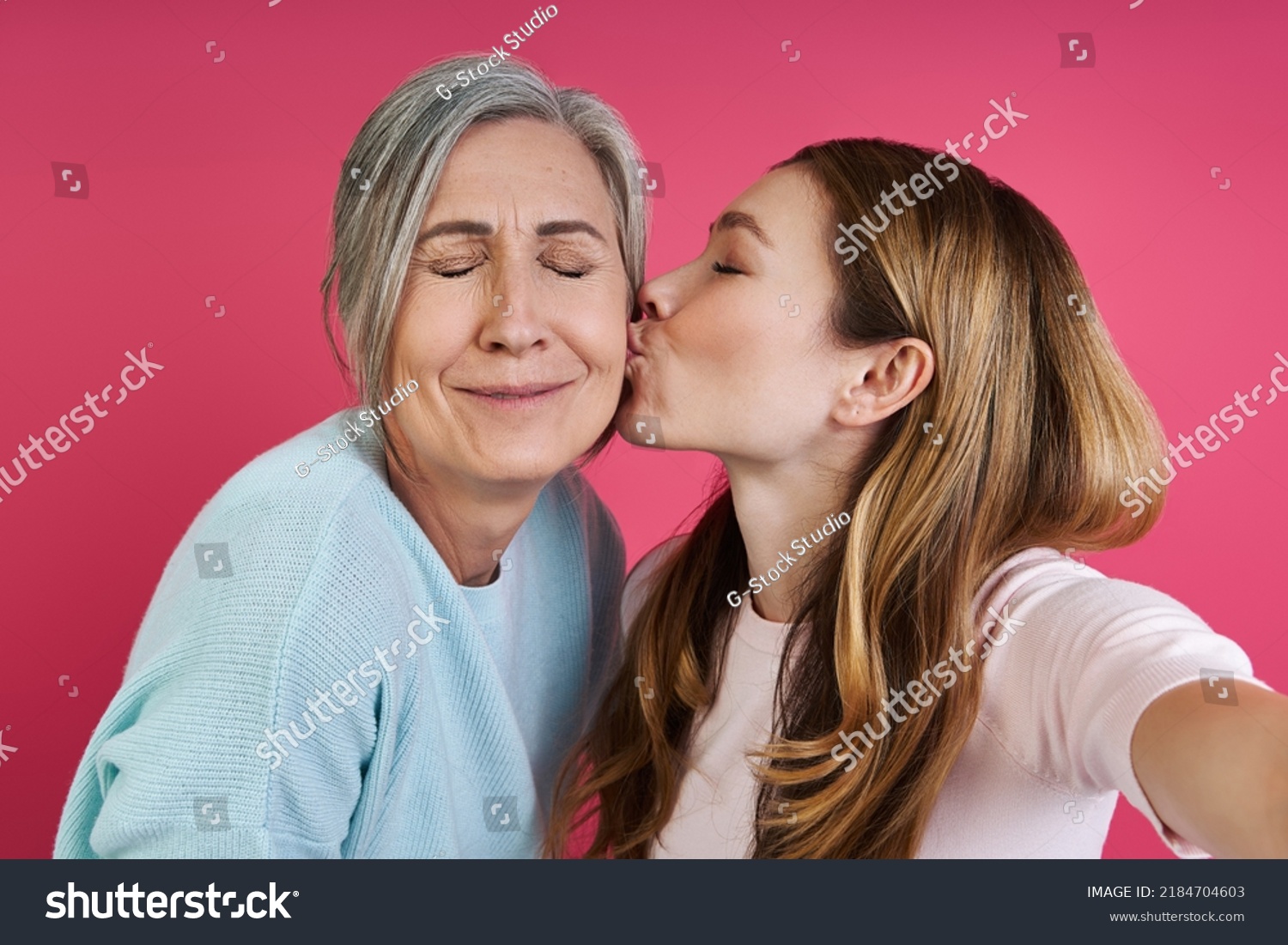 Стоковая фотография 2184704603 Adult Daughter Kissing Her Senior Mother Shutterstock 