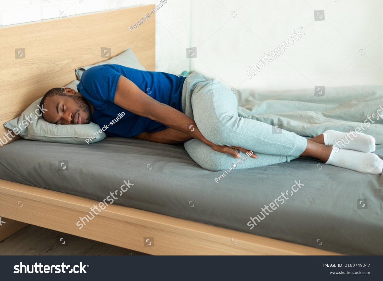 african-american-young-man-sleeping-on-stock-photo-2188749047