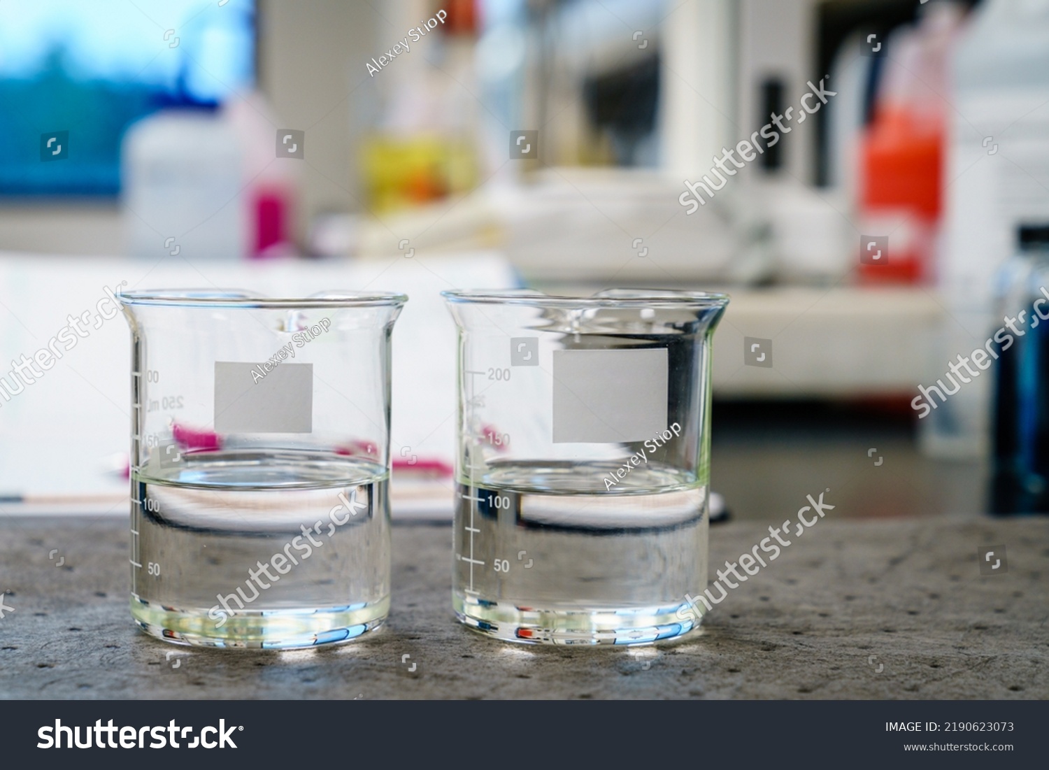 Two beakers clear liquids blank labels stock photo 2190623073