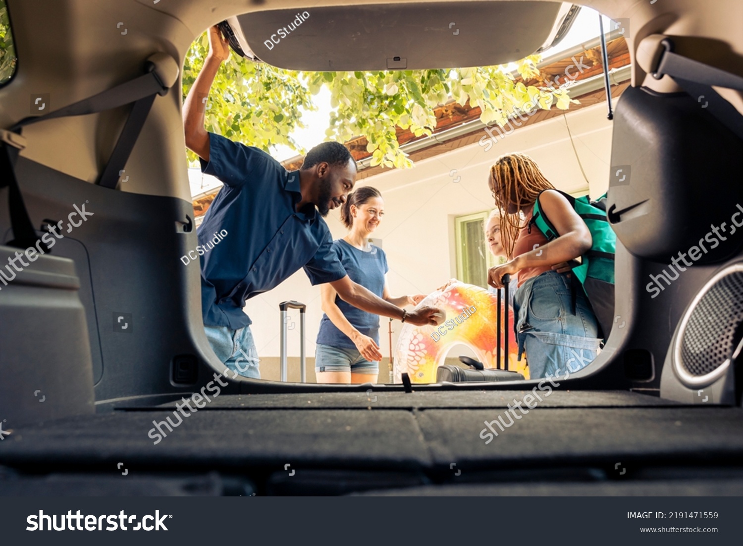 Stock Photo Multiethnic People Loading Baggage In Trunk Preparing Car With Trolley And Travel Bags To Leave On 2191471559 