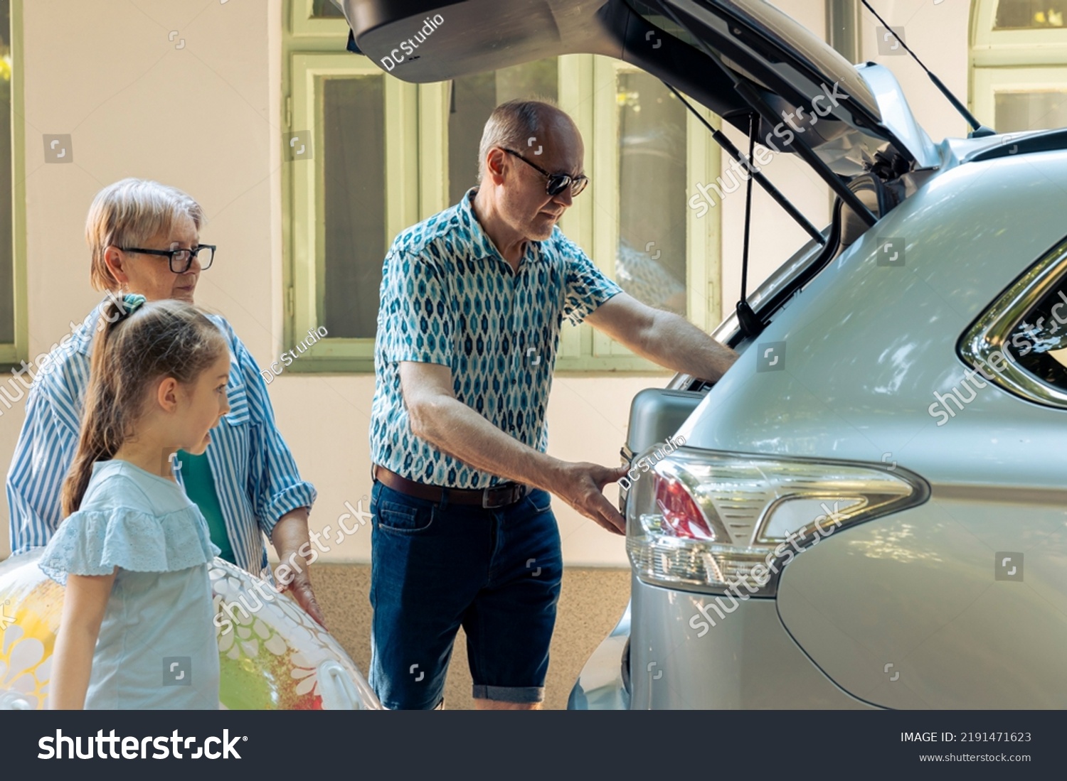 senior-people-taking-child-on-holiday-stock-photo-2191471623-shutterstock