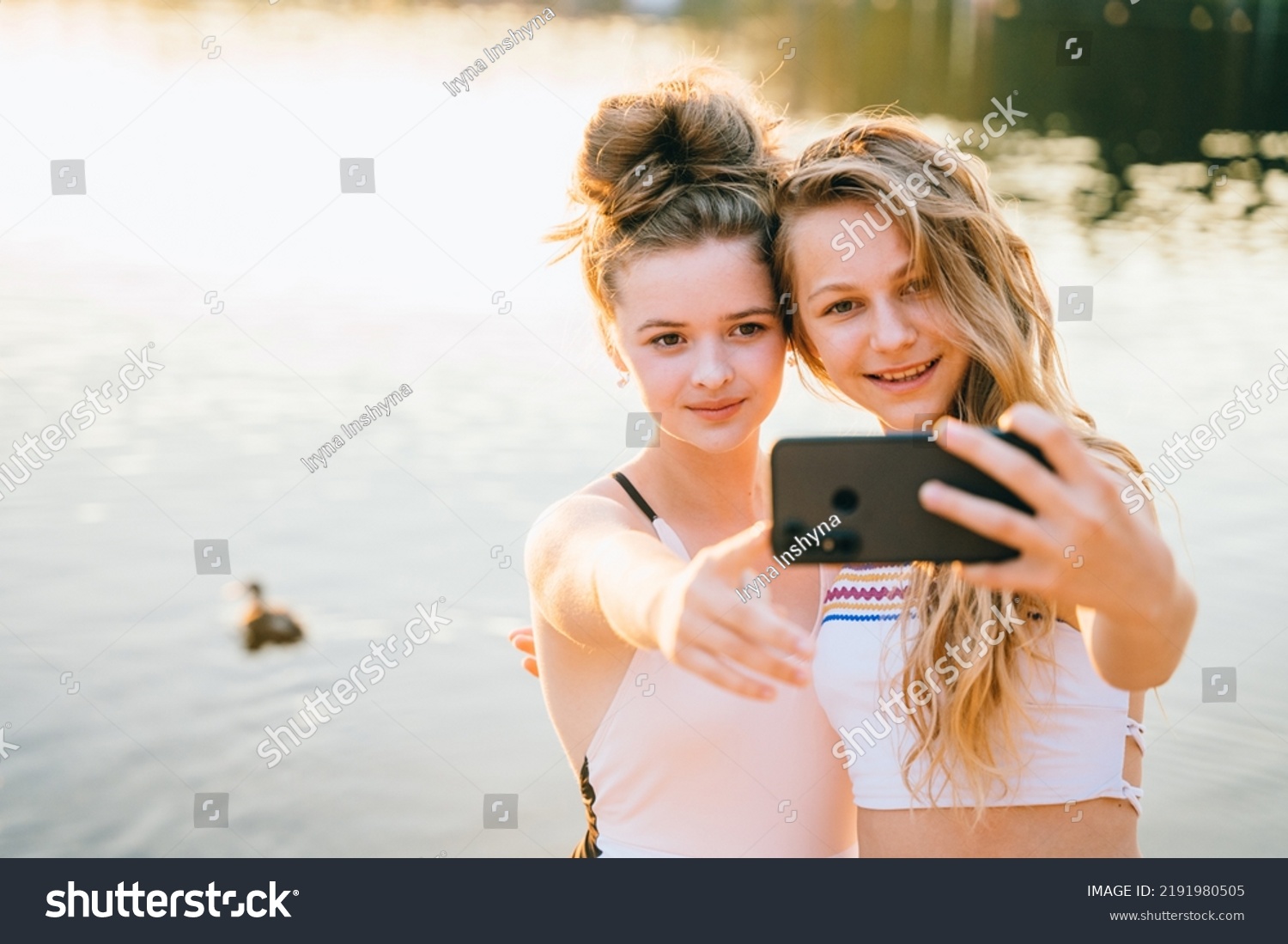 Стоковая фотография 2191980505 Two Girls Bikini On Beach Enjoying